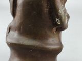 brown ceramic statue of a man with a hat on his head