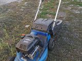 an image of a lawn mower sitting in the grass