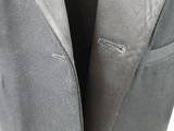 a close up of a suit jacket with a hole in it