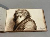 un vieux livre sur lequel figure le dessin d'un homme à la longue barbe