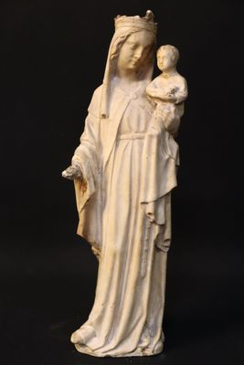 a white statue of a woman holding a baby in her arms