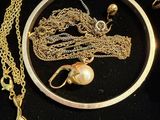 a picture of a necklace and a ring with a pearl on it