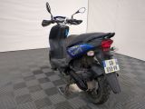 a scooter that is parked on a checkered floor