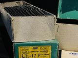 two boxes of electrical equipment sitting on a table