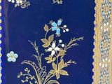an image of a blue and gold case with flowers on it