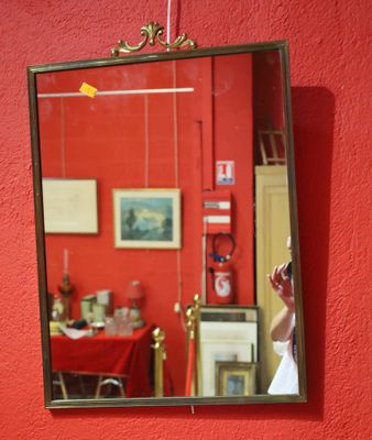 a woman taking a picture of herself in a mirror