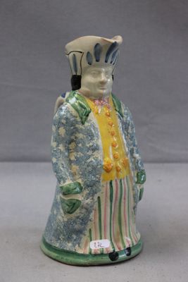 a ceramic figurine of a man in a suit and tie