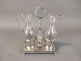 three glass vases on a silver tray on a table