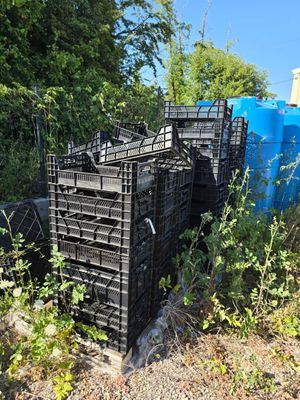 a pile of crates sitting on the side of the road