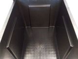 a metal box with a lid open on the floor