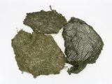 three pieces of green fabric on a white surface