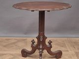 a small table with a wooden top on a parquet floor