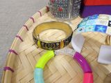 a tray with bracelets, bracelets, and other items on it