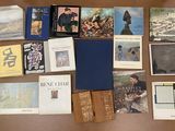 a lot of books on the table with pictures on them
