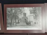 a picture of a horse drawn carriage in front of a building