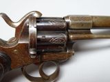 a close up of a gun on a white surface