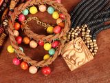 many different colored beads on a wooden table