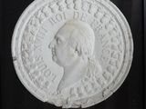 an image of a white medallion with a man ' s face on it