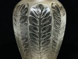 un vase en verre orné d'un motif de feuilles
