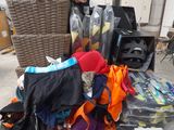 a pile of clothing on a carton in a garage