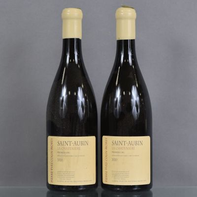 two bottles of wine sitting on top of a table next to each other