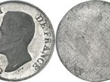 a close up of a silver coin with a profile of a man on it
