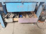 a blue workbench with a bunch of tools in it