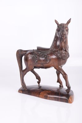 statue of a horse on a wooden base with a white background