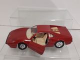 a red toy car in a clear box on a table