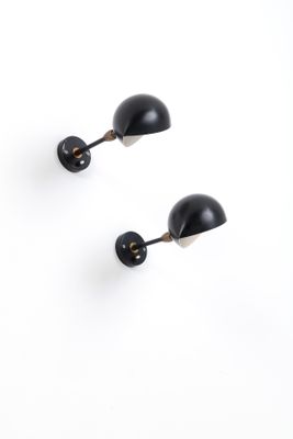 pair of black wall lamps on a white background