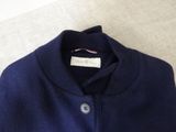 the back of a blue sweater with a buttoned collar