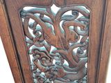 carvings on the side of a wooden cabinet are intricately carved