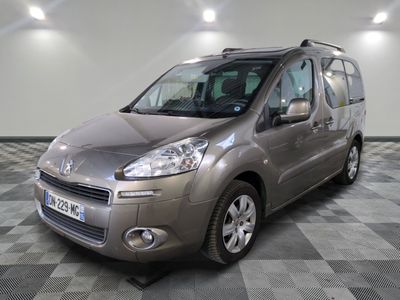 the silver van is parked on a checkered floor in a garage