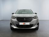 the front view of a silver car in a white room