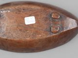 a small wooden object on a table with a tag on it