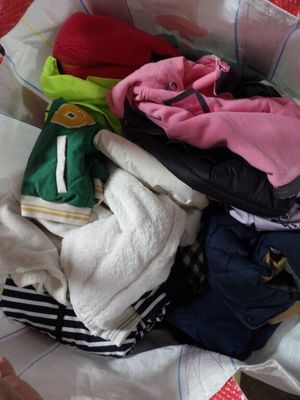 un tas de vêtements dans un sac posé par terre
