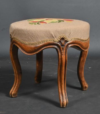 a small wooden stool with a floral design on it