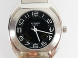 a silver watch with a black face and numbers on it