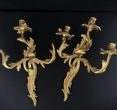 a pair of antique brass wall sconces with flowers and leaves
