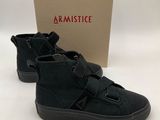 a pair of black sneakers with a box in the background