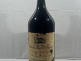 a bottle of wine sitting on top of a white table