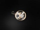 an image of a gold pendant with a horse in the center