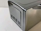 a silver microwave oven sitting on a counter top
