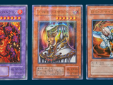 three cards of different colors and designs on a blue background