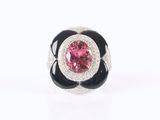 a close up of a ring with a pink and black flower