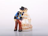 a figurine of a man and a woman holding hands