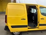 a yellow van parked in a parking lot with its doors open