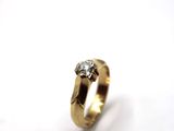 a close up of a gold ring with a diamond on it