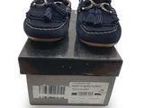 navy blue leather shoes with tassels on top of a box