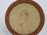 a picture of a young boy in a picture frame